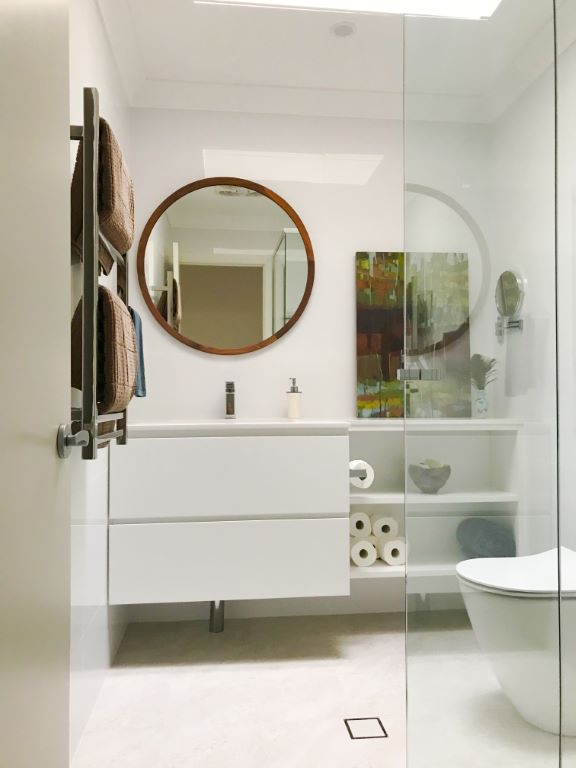 Compact Contemporary Bathroom with Timber Framed Mirror and Artwork
